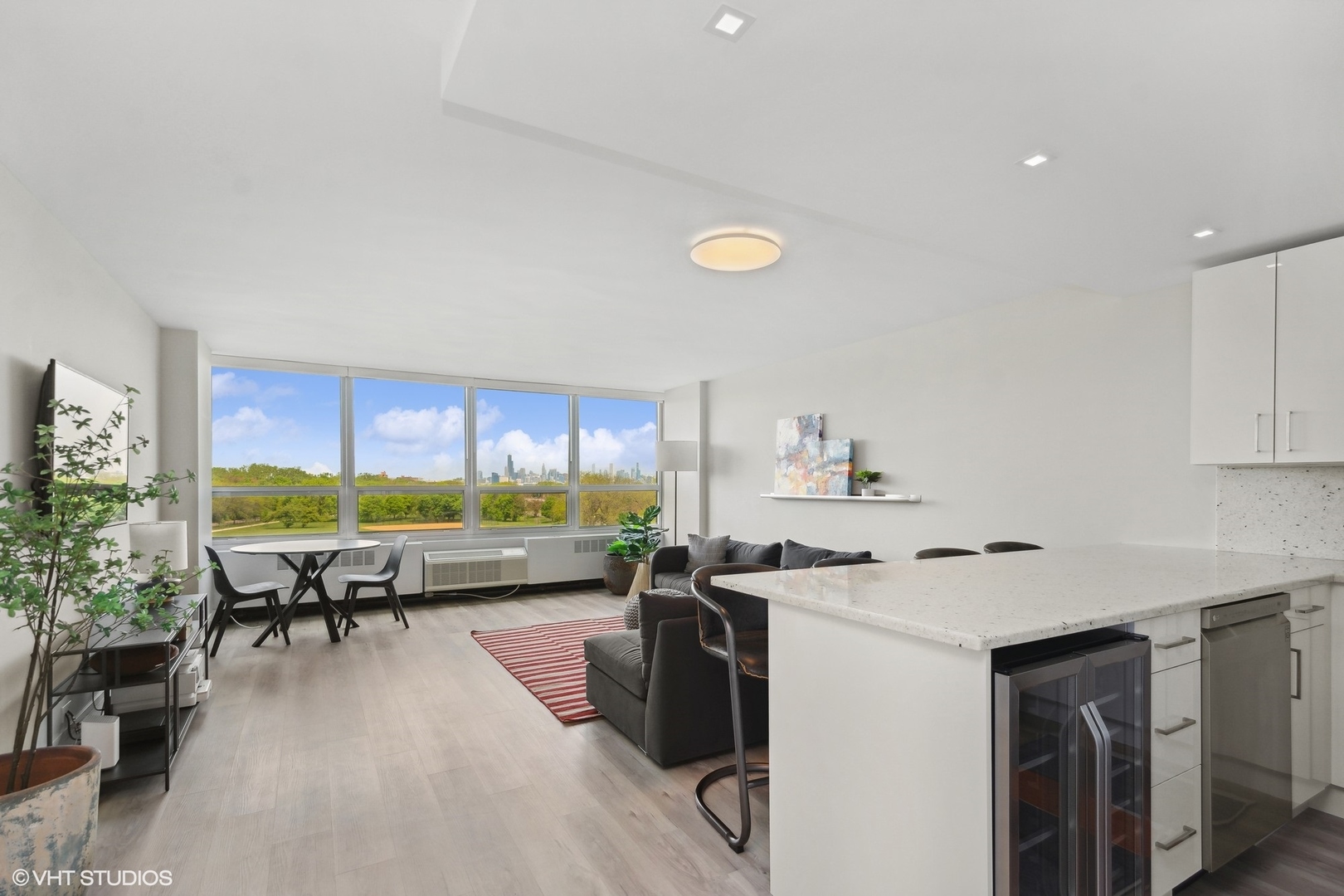 4800 South Chicago Beach Drive, Unit 503N Chicago, IL 60615 - Photo 5 of 15 a kitchen with a table chairs stove and a wooden floor