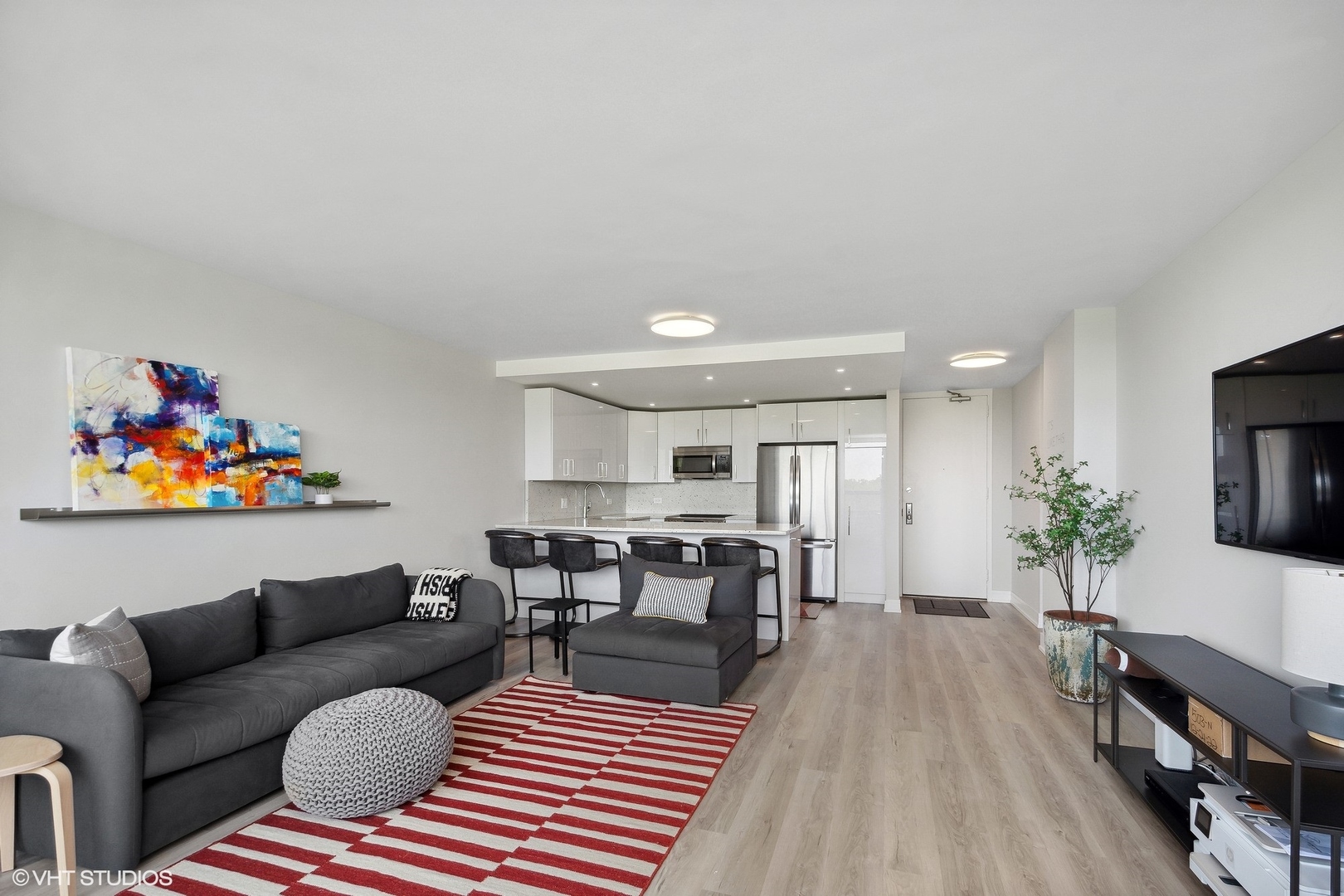 4800 South Chicago Beach Drive, Unit 503N Chicago, IL 60615 - Photo 10 of 15 a living room with furniture a flat screen tv and a rug
