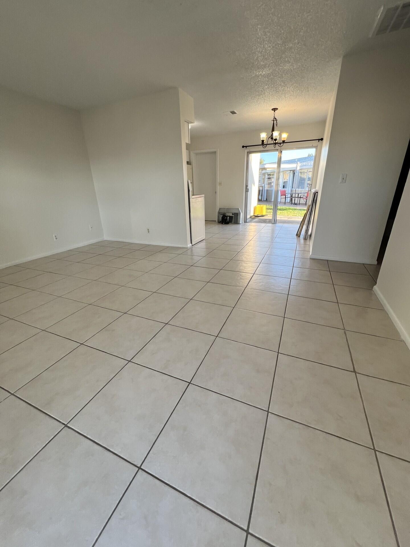 2845 Duke Lane Delray Beach, FL 33445 - Photo 11 of 15 a view of an empty room and a kitchen