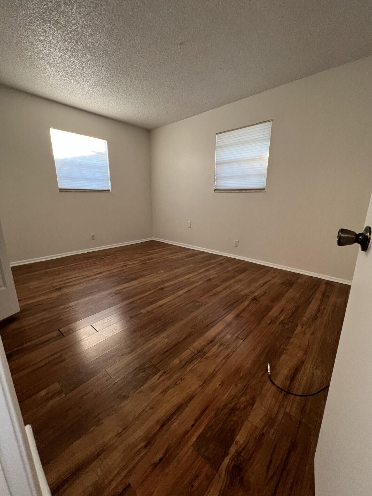 2845 Duke Lane Delray Beach, FL 33445 - Photo 13 of 15 a view of an empty room with wooden floor and a window
