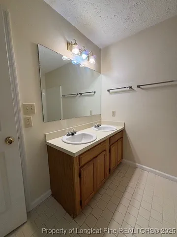 an empty room with windows and chandelier fan