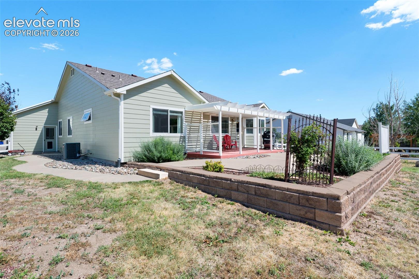 7840 Midnight Road Peyton, CO 80831 - Photo 40 of 48 A good sized wood deck and pergola open to a large extended concrete patio