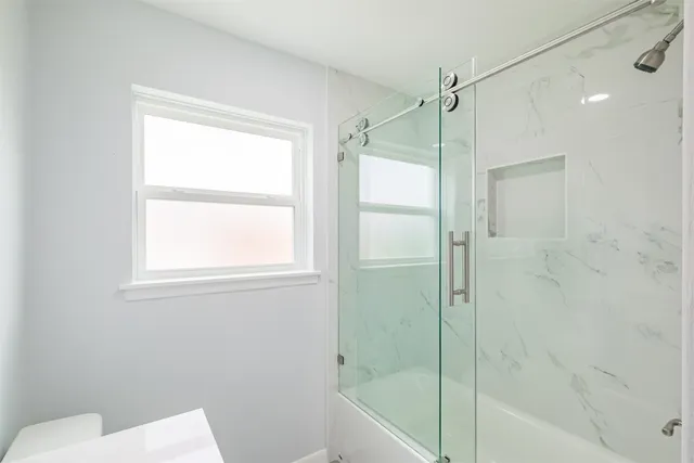 a bathroom with a shower and a toilet sink