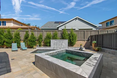 a view of house with swimming pool yard and outdoor seating