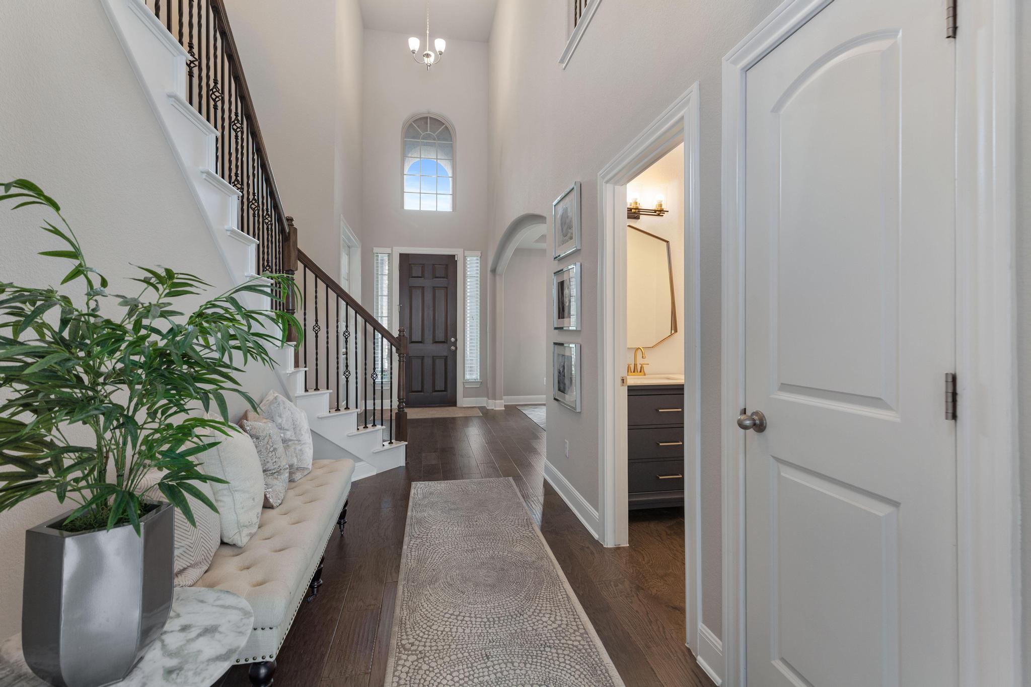 3028 Silvergrass Cove Leander, TX 78641 - Photo 2 of 38 Entryway featuring a high ceiling and dark wood-type flooring