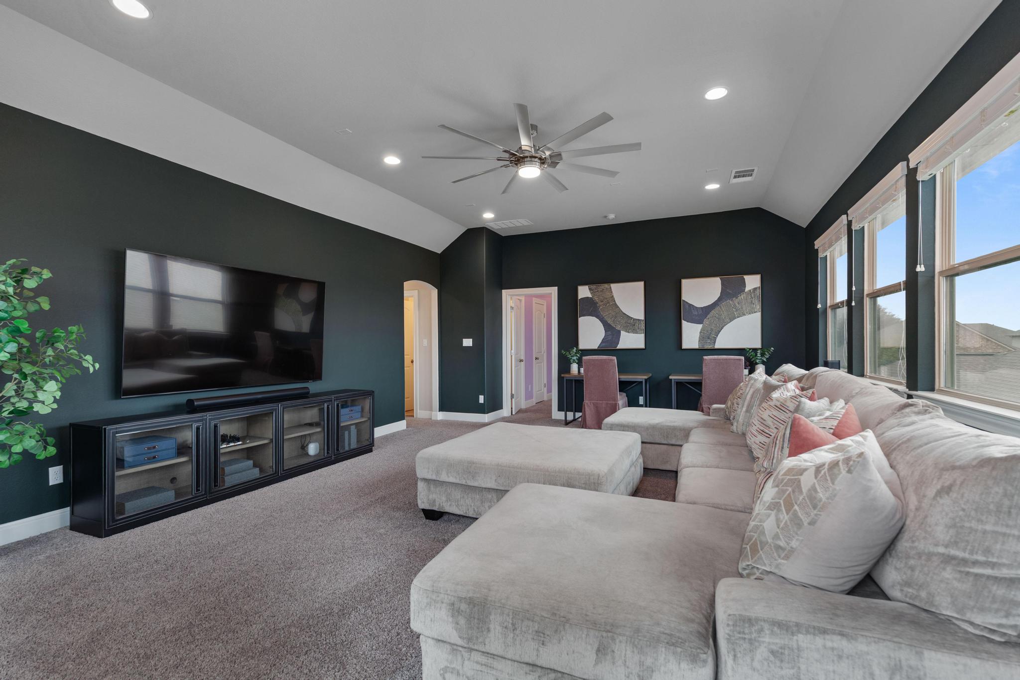 3028 Silvergrass Cove Leander, TX 78641 - Photo 21 of 38 Carpeted living room with a ceiling fan, recessed lighting, vaulted ceiling, and arched walkways