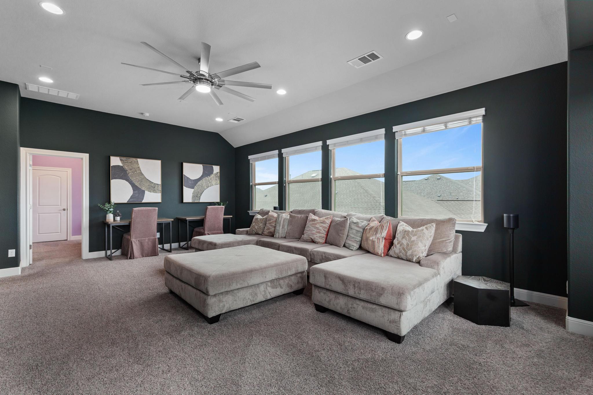 3028 Silvergrass Cove Leander, TX 78641 - Photo 22 of 38 Living area featuring ceiling fan, a desk, carpet, recessed lighting, and lofted ceiling