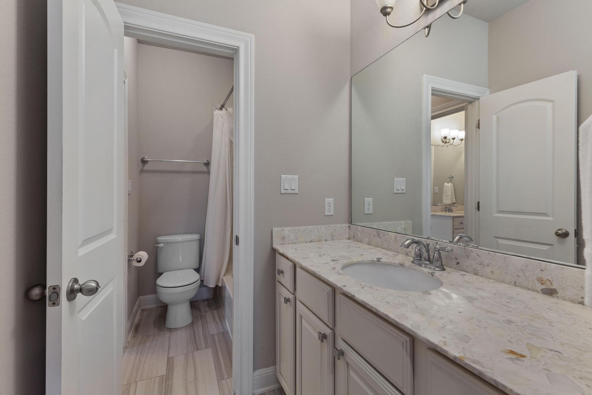 3028 Silvergrass Cove Leander, TX 78641 - Photo 30 of 38 Bathroom with vanity, a chandelier, and shower / tub combo with curtain