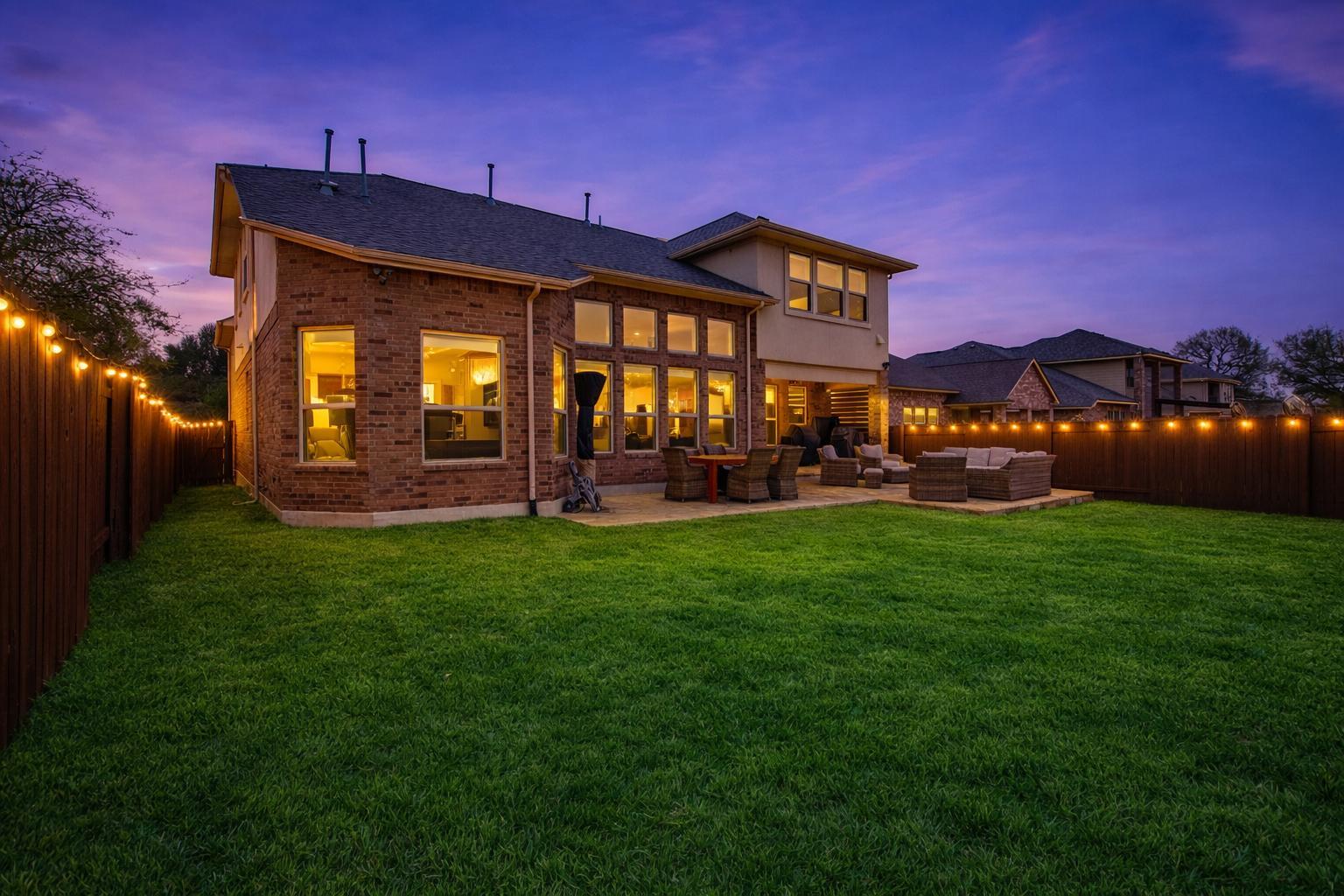 3028 Silvergrass Cove Leander, TX 78641 - Photo 33 of 38 Rear view of property with a fenced backyard, a patio, outdoor seating, brick siding, and roof with shingles