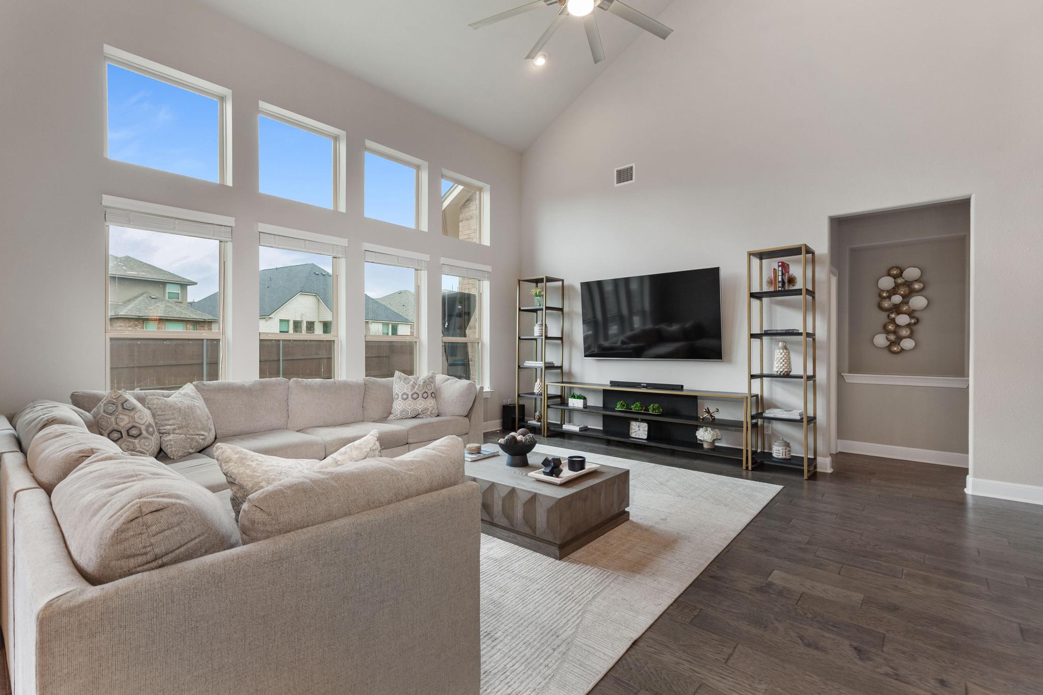 3028 Silvergrass Cove Leander, TX 78641 - Photo 9 of 38 Living area featuring lofted ceiling, dark wood-style floors, a ceiling fan, and recessed lighting