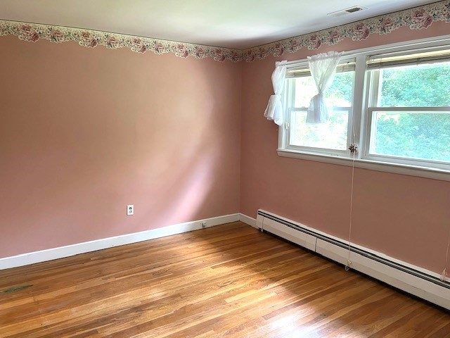 21 Chamberlain Road Chelmsford, MA 01824 - Photo 12 of 13 a view of empty room with wooden floor and fan