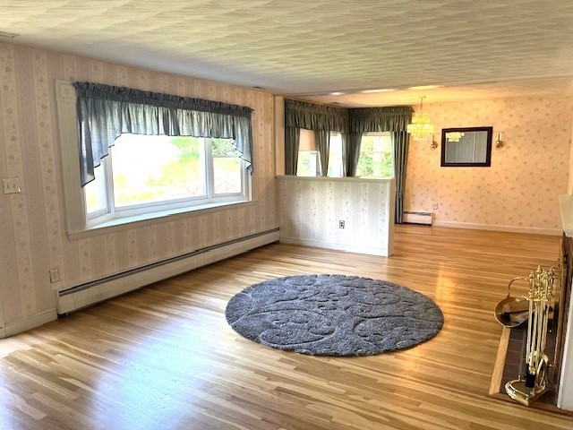 21 Chamberlain Road Chelmsford, MA 01824 - Photo 3 of 13 a view of an empty room with wooden floor and a window