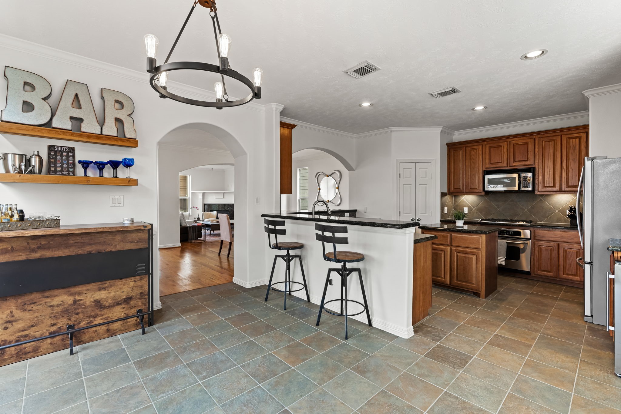 1846 Stacy Crest Houston, TX 77008 - Photo 13 of 32 a kitchen with stainless steel appliances kitchen island granite countertop a stove a sink a oven and a dining table with wooden cabinet