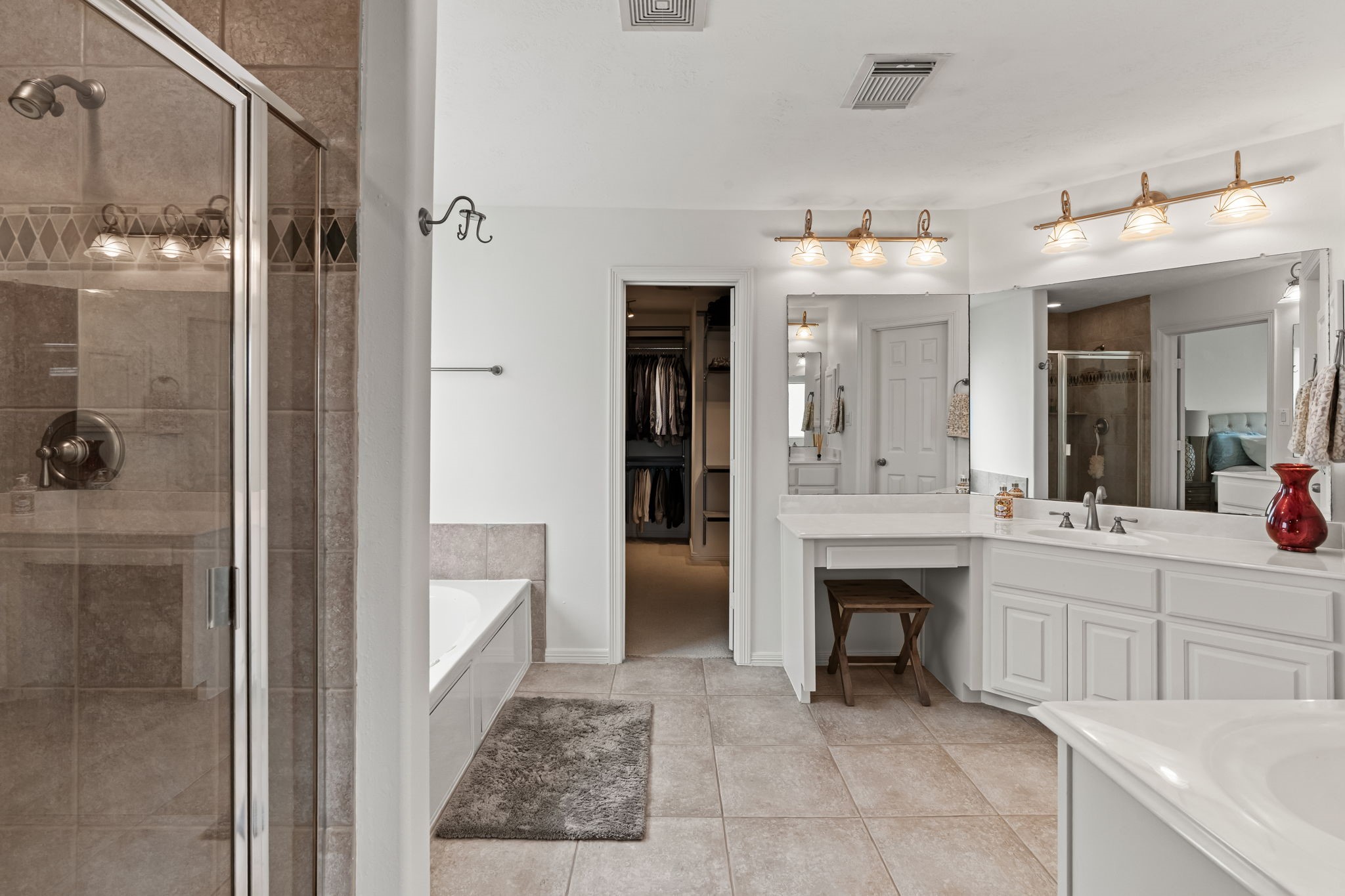 1846 Stacy Crest Houston, TX 77008 - Photo 17 of 32 The primary bathroom unfolds into a spacious, spa-like setting, complete with a soaking tub, walk-in shower, and dual vanities. The layout provides plenty of room to get ready with ease, all while maintaining a clean and open feel.
