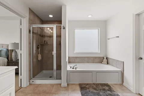 a bathroom with a tub and shower