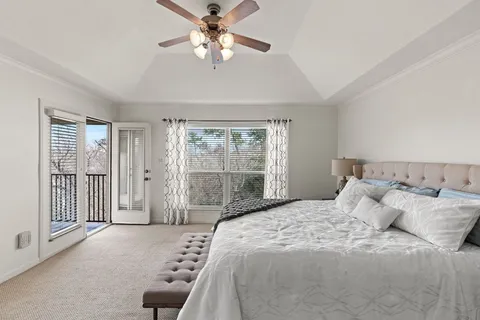 a bedroom with a large bed and a window