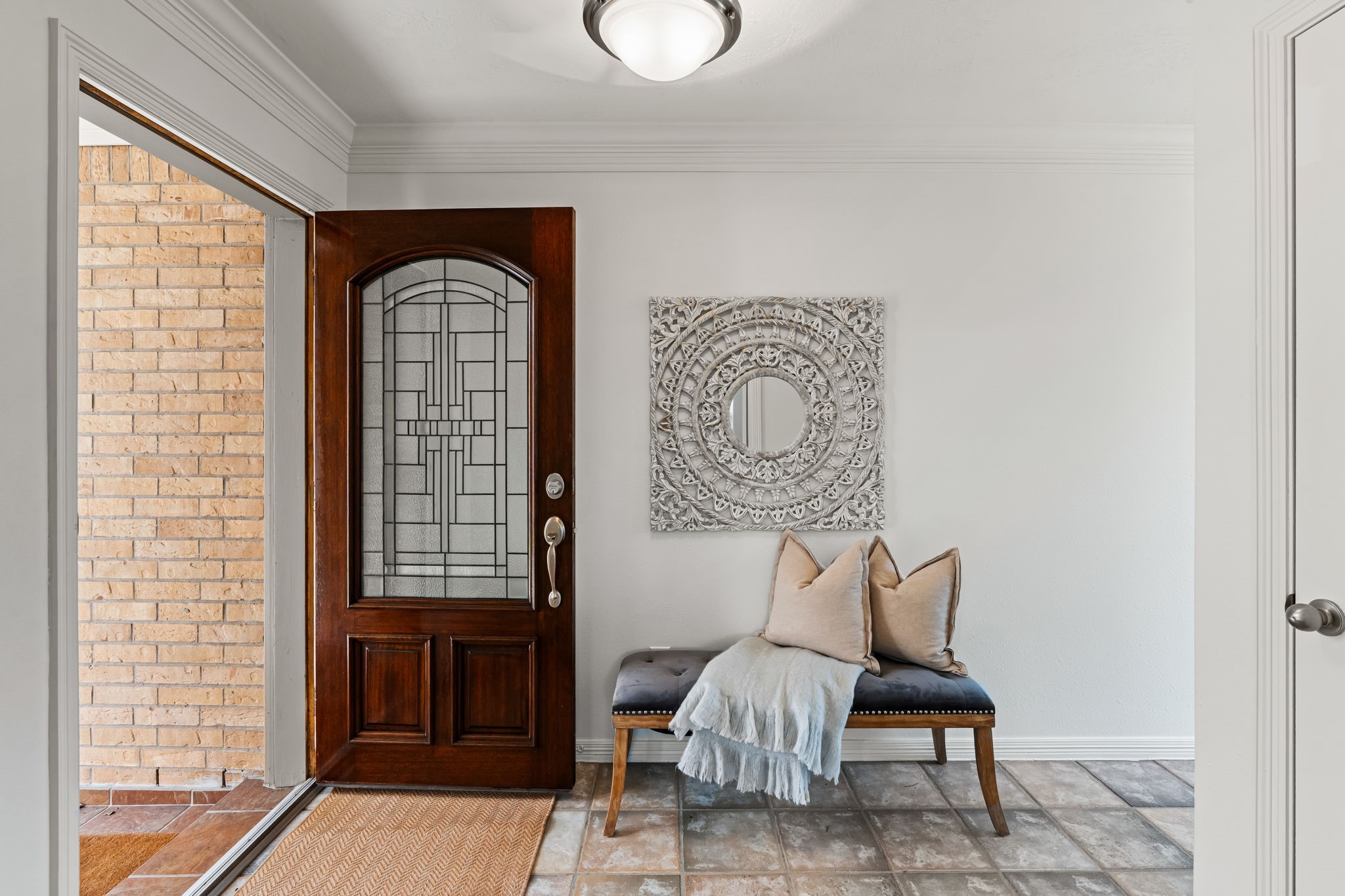 1846 Stacy Crest Houston, TX 77008 - Photo 5 of 32 The foyer introduces the home with soft natural light, crown molding, and tiled flooring that extends through the entry level. This welcoming space sets the tone as you prepare to move upstairs to the main living areas. Note, the entire interior of the home was just freshly painted, making it move-in ready!