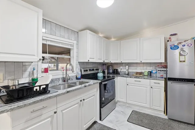 a kitchen with cabinets a sink and appliances