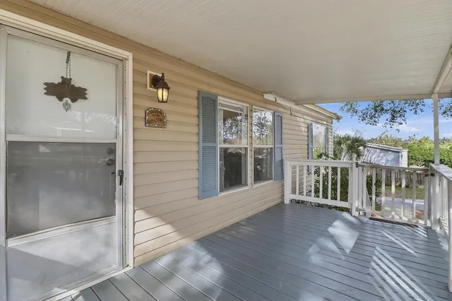 a view of a balcony with wooden floor