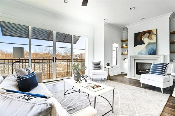 a living room with furniture a fireplace and a floor to ceiling window