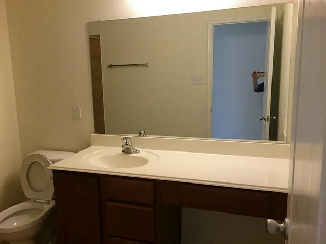 a bathroom with a shower and a mirror