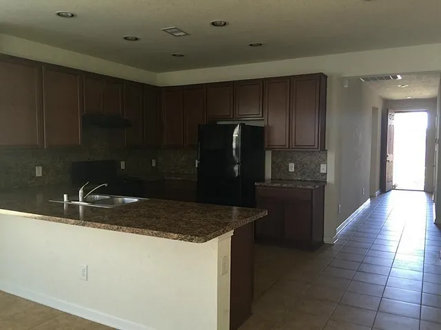 a kitchen with a sink and refrigerator