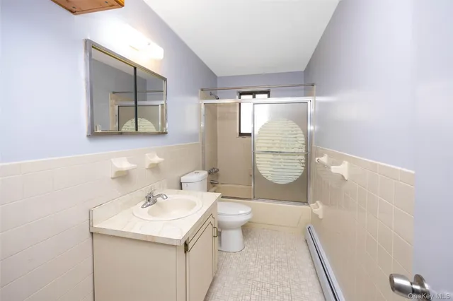 a bathroom with a sink a toilet and mirror