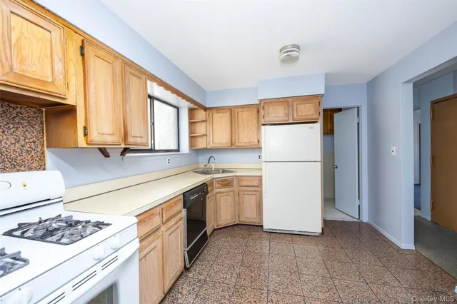 a kitchen with a refrigerator and a sink