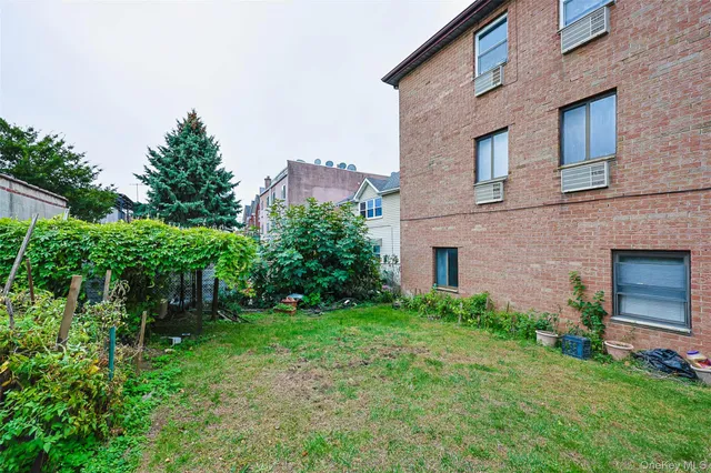a brick building with a yard in front of it
