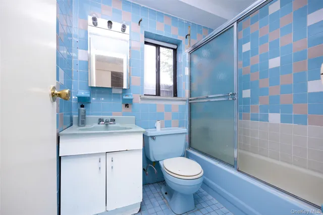a bathroom with a granite countertop toilet a sink and a bathtub