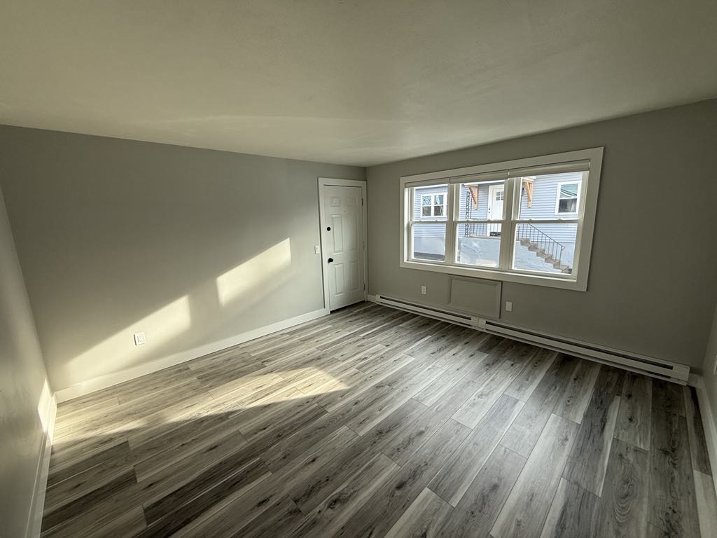 12 Hunnewell Road, Unit 2R Worcester, MA 01606 - Photo 11 of 13 a view of an empty room with wooden floor and a window
