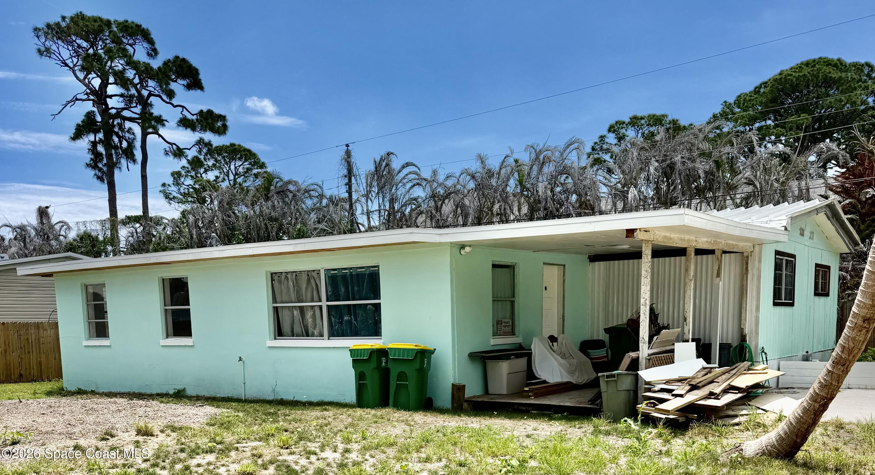 1925 Monticello Avenue Merritt Island, FL 32952 - Photo 1 of 17 a view of a backyard with plants and barbeque grill