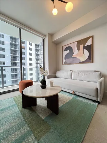 a living room with furniture and a large window