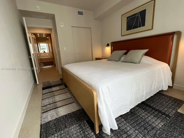 a bedroom with a bed and a mirror