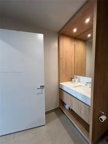a bathroom with a double vanity sink and mirror