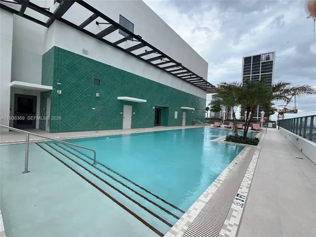 a view of pool with seating area
