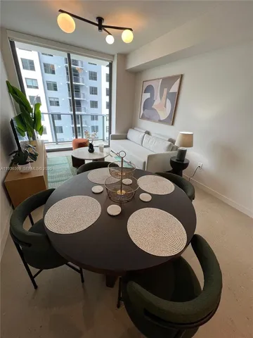 a view of a dining room with furniture and window