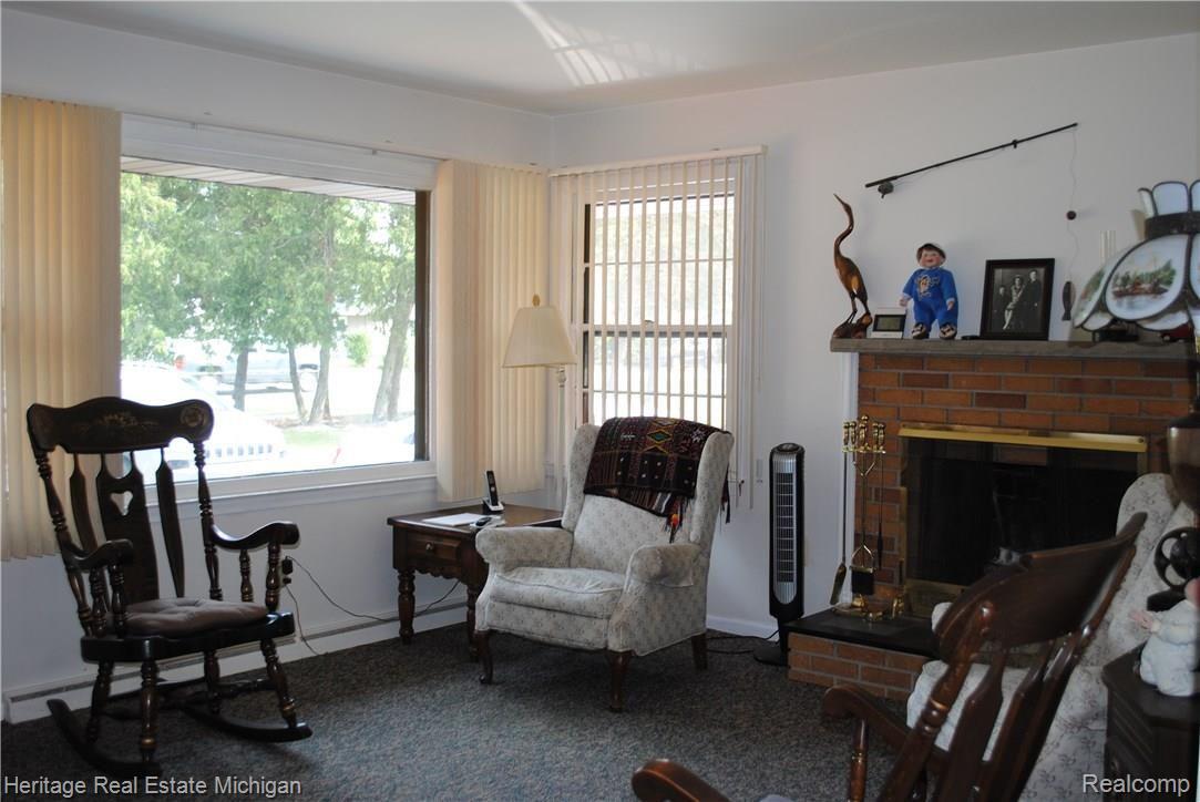This view of the sun-lit living room shows the natural fireplace!