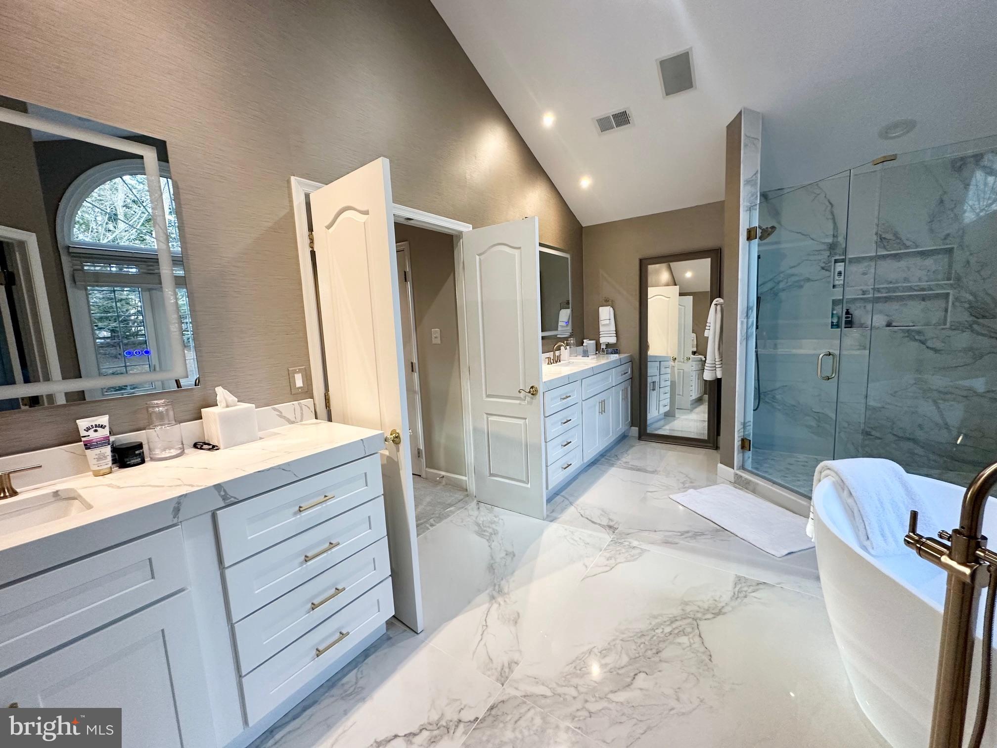 13701 Goosefoot Terrace Rockville, MD 20850 - Photo 12 of 16 a spacious bathroom with double vanity a mirror and a shower