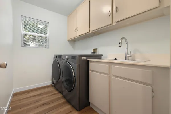 a utility room with sink dryer and washer
