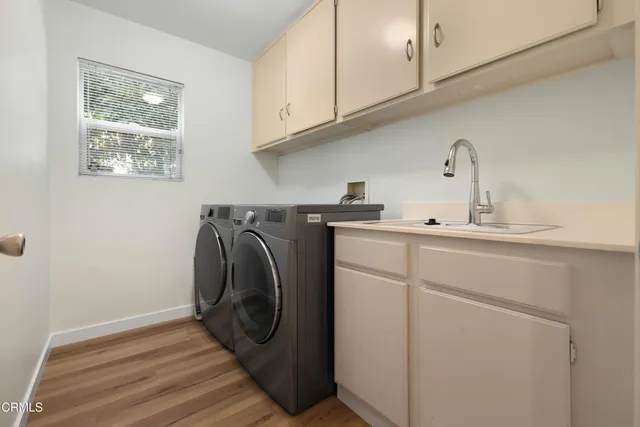 a utility room with sink dryer and washer