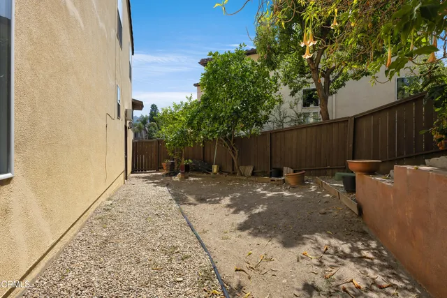 a backyard of a house with yard and outdoor seating
