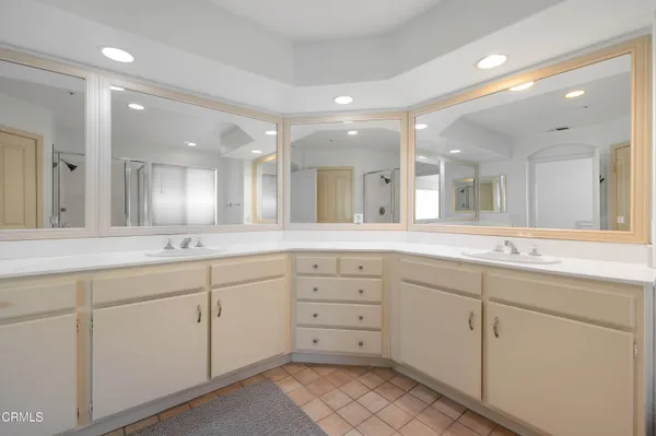 a large bathroom with a large mirror vanity and double vanity
