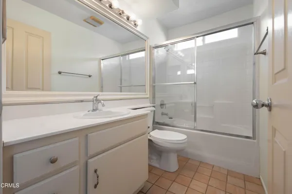 a bathroom with a sink toilet a mirror and shower