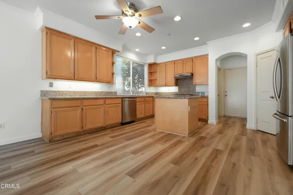 a kitchen with stainless steel appliances granite countertop a sink and cabinets