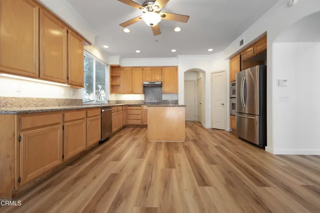 a kitchen with stainless steel appliances a refrigerator sink and cabinets