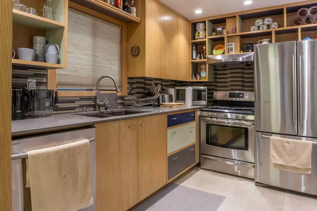 a kitchen with stainless steel appliances granite countertop a stove and a sink