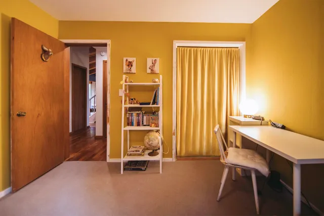 a dining room with furniture and a window