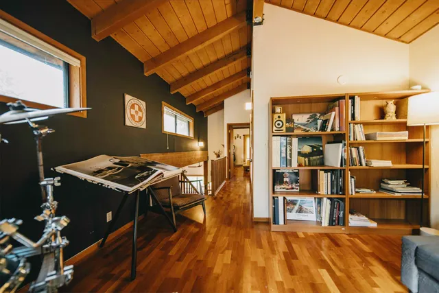 a livingroom with workspace and a window
