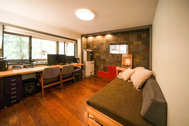 a bedroom with furniture and a large window